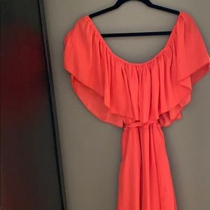 Peach colored off the shoulder dress.
